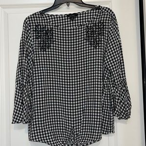 Black blouse/white checks.  Cute flared sleeves and tie at waist.